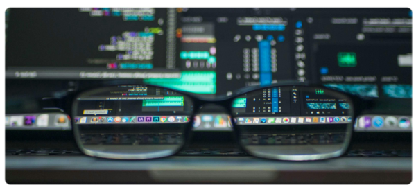 Reading classes sit in front of a computer screen with several lines of code